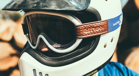 White motorcycle googles over glasses