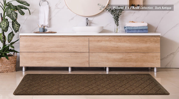 A gently used arbor collection mat in front of a nice bathroom vanity