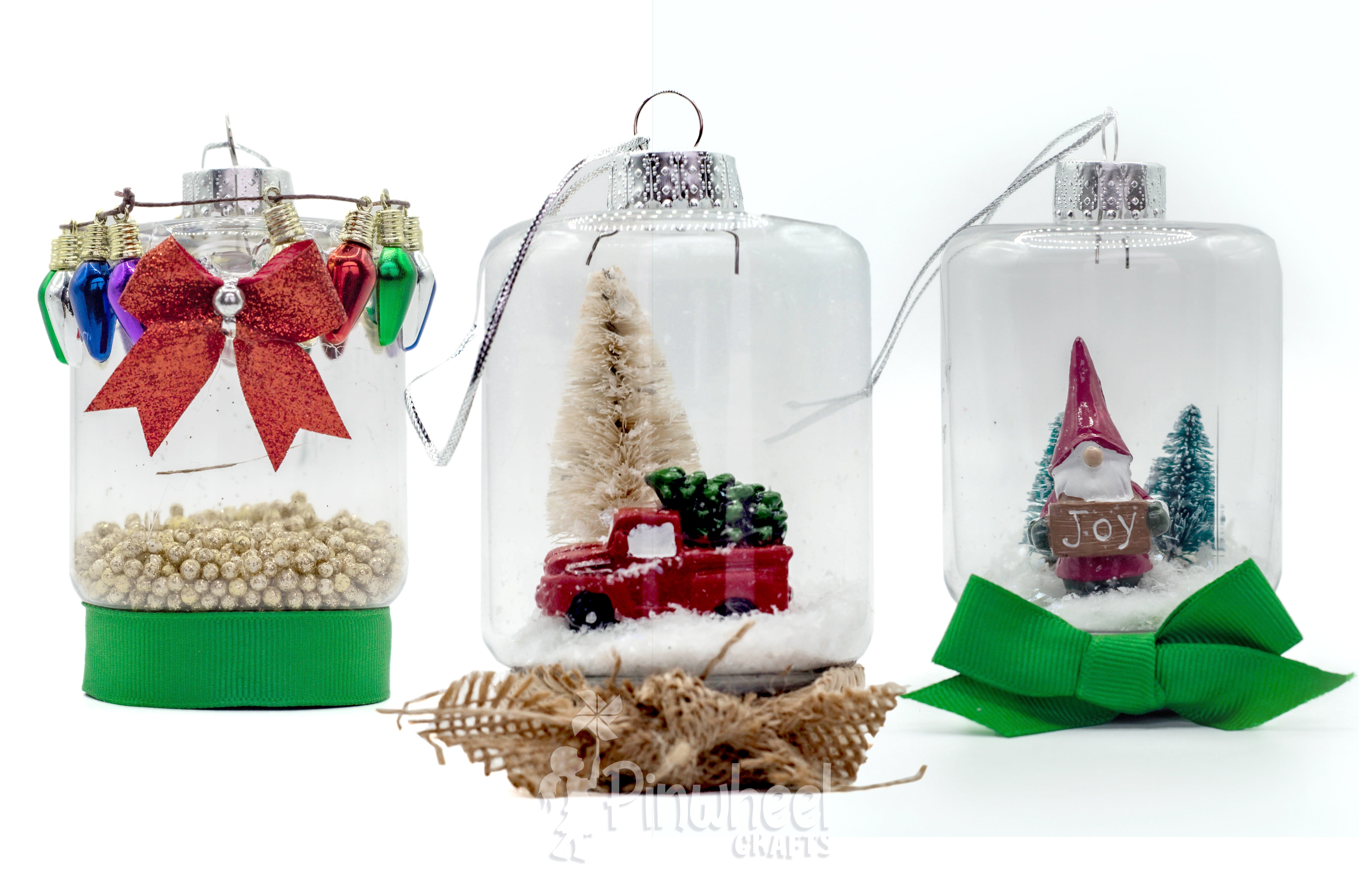 Pinwheel Crafts all-in-one diy craft kit mason jar fairy lanterns set upside down with holiday figures inside and ornament cap on top to make them look like Christmas tree ornaments