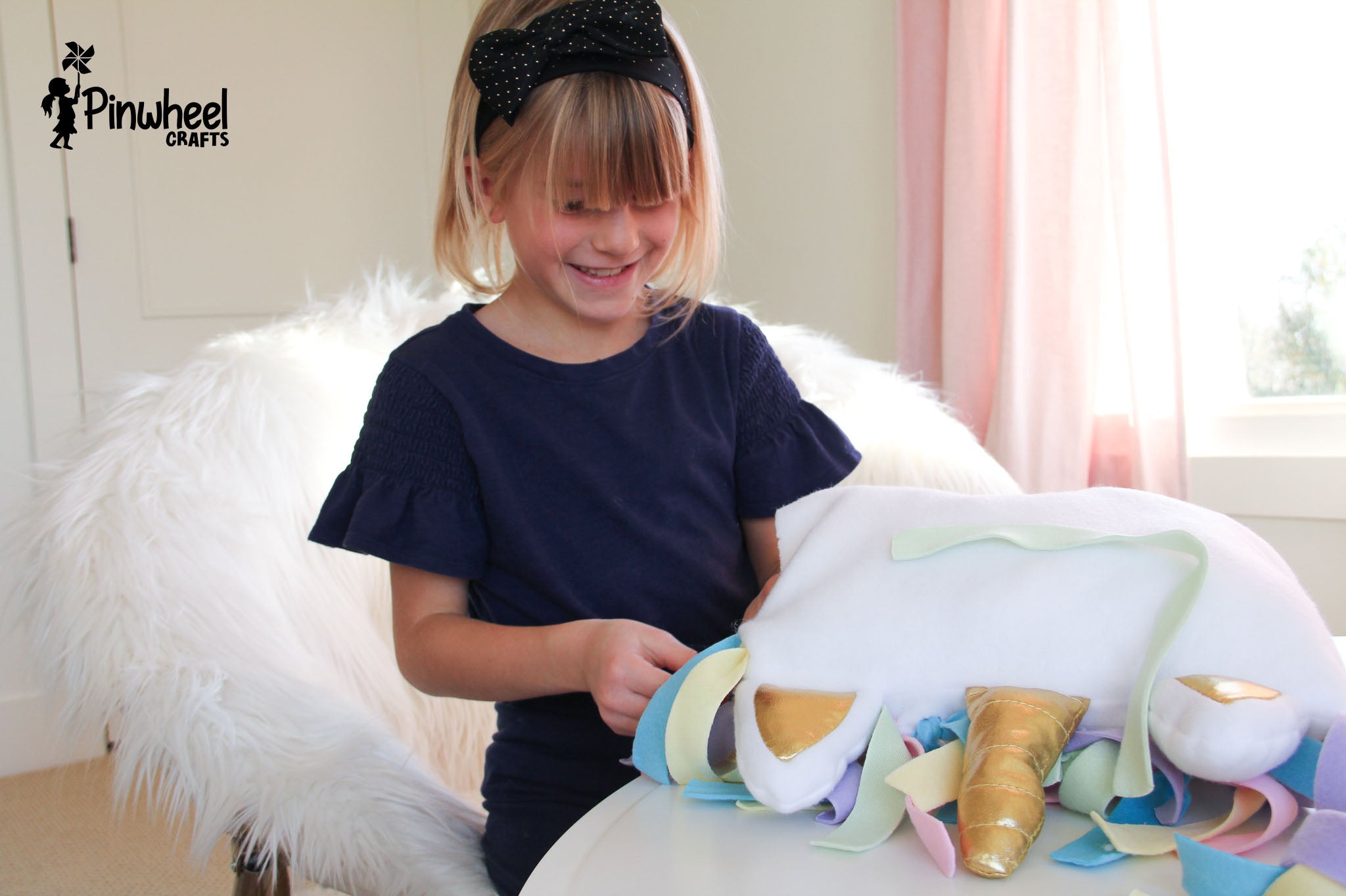 young child crafting a unicorn pillow