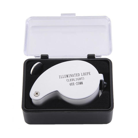 Image: Small black case with clear lid holds a silver loupe