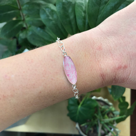 pink breast cancer awareness identity bracelet on wrist