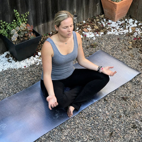 nikki meditating in her garden