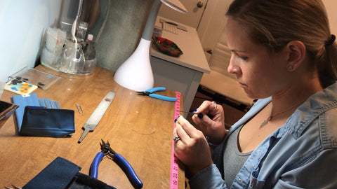 Nikki working at bench finishing jewelry