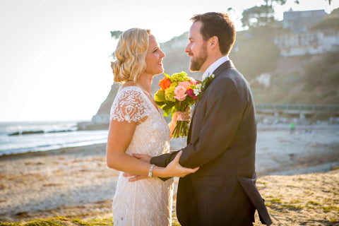 Nikki and her husband Rob on their wedding day at the beach