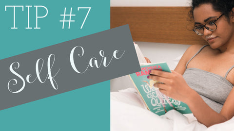 woman in bed reading a book tip #7 self care