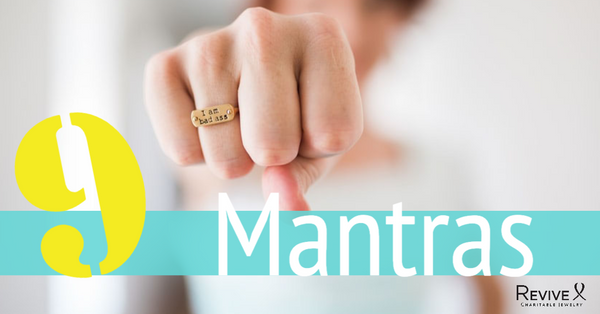 woman holding fist out wearing ring that says I am bad ass 9 mantras