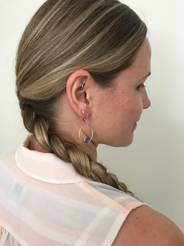 side view of side braid and hoop earrings