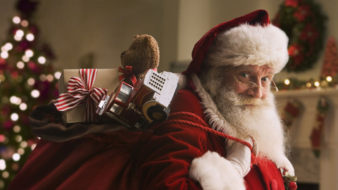 man dressed up as one of santa's human helpers