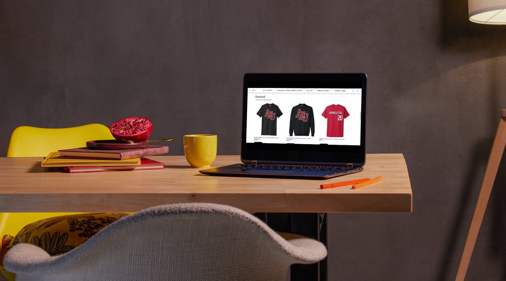 A laptop on a table with an image of an online t-shirt fundraising.