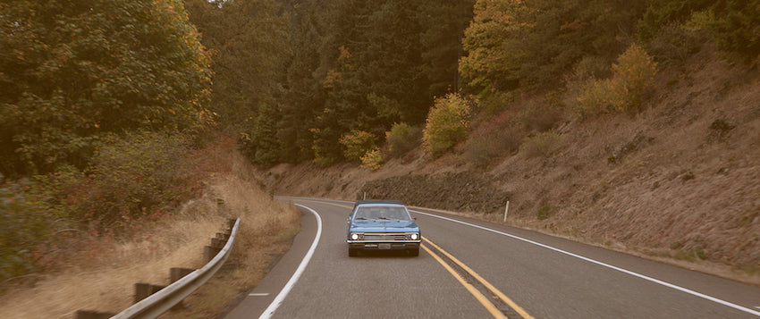 Old car driving on the highway.