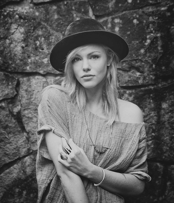 Black and white photograph of model wearing betsy and iya jewelry, dressed in a modern hipster style.
