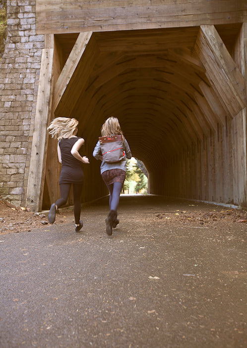 Girls running through a tunnel in Oregon.