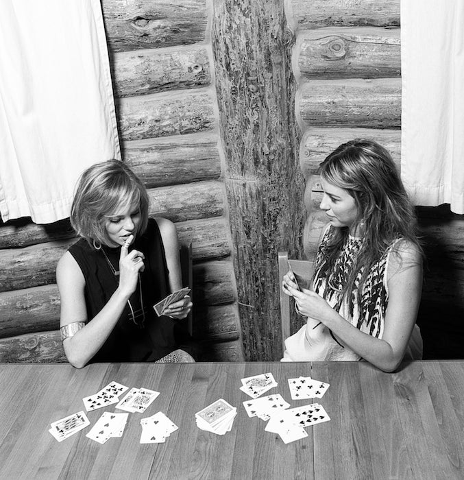 Two models playing cars in a cabin wearing lots of betsy & iya jewelry.