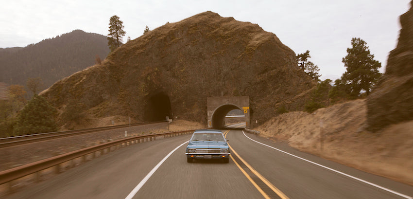 Photograph of an old car on a road trip through the Columbia Gorge.