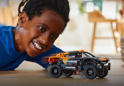 Boy playing with Lego Technic toy