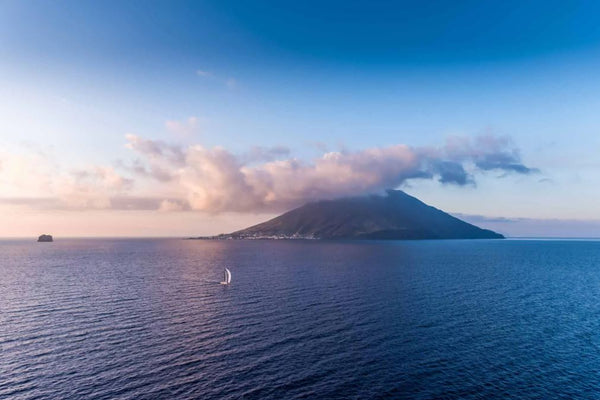 Blur sailing in the Rolex Middle Sea Race past Stromboli volcano