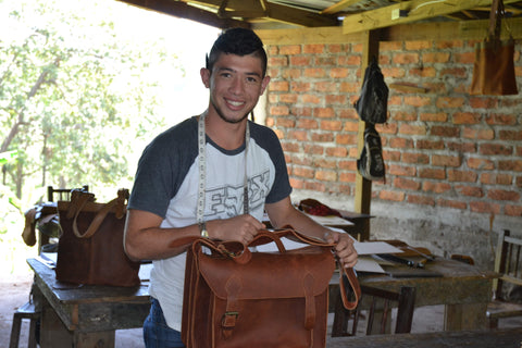 Brayan with a leather briefcase he made