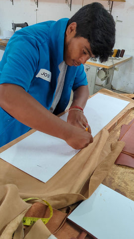 Jose Luis works on a new leather design