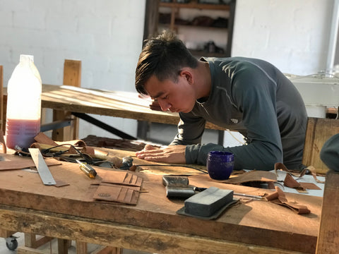 Kilmer working at the Lazarus Artisan Goods leather shop