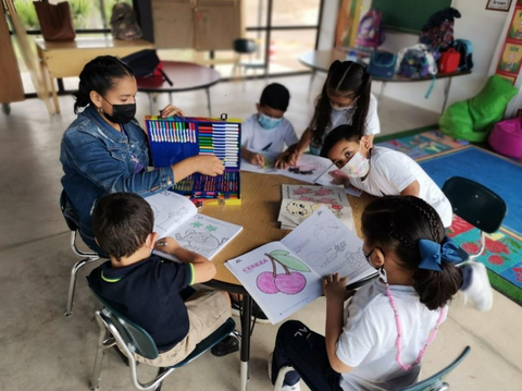 Nidia assisting a kindergarten class at Lazarus Academy