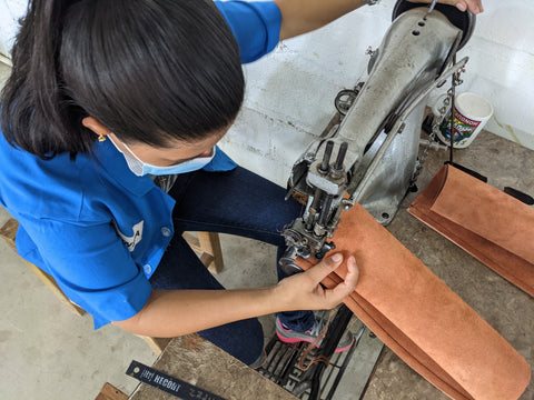 leather artisan in Honduras sewing