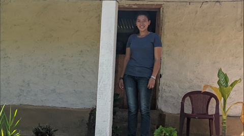 Juventina in front of her house in Honduras