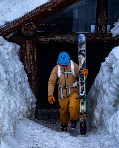 skier leaving hut with best backcountry skis the prospector