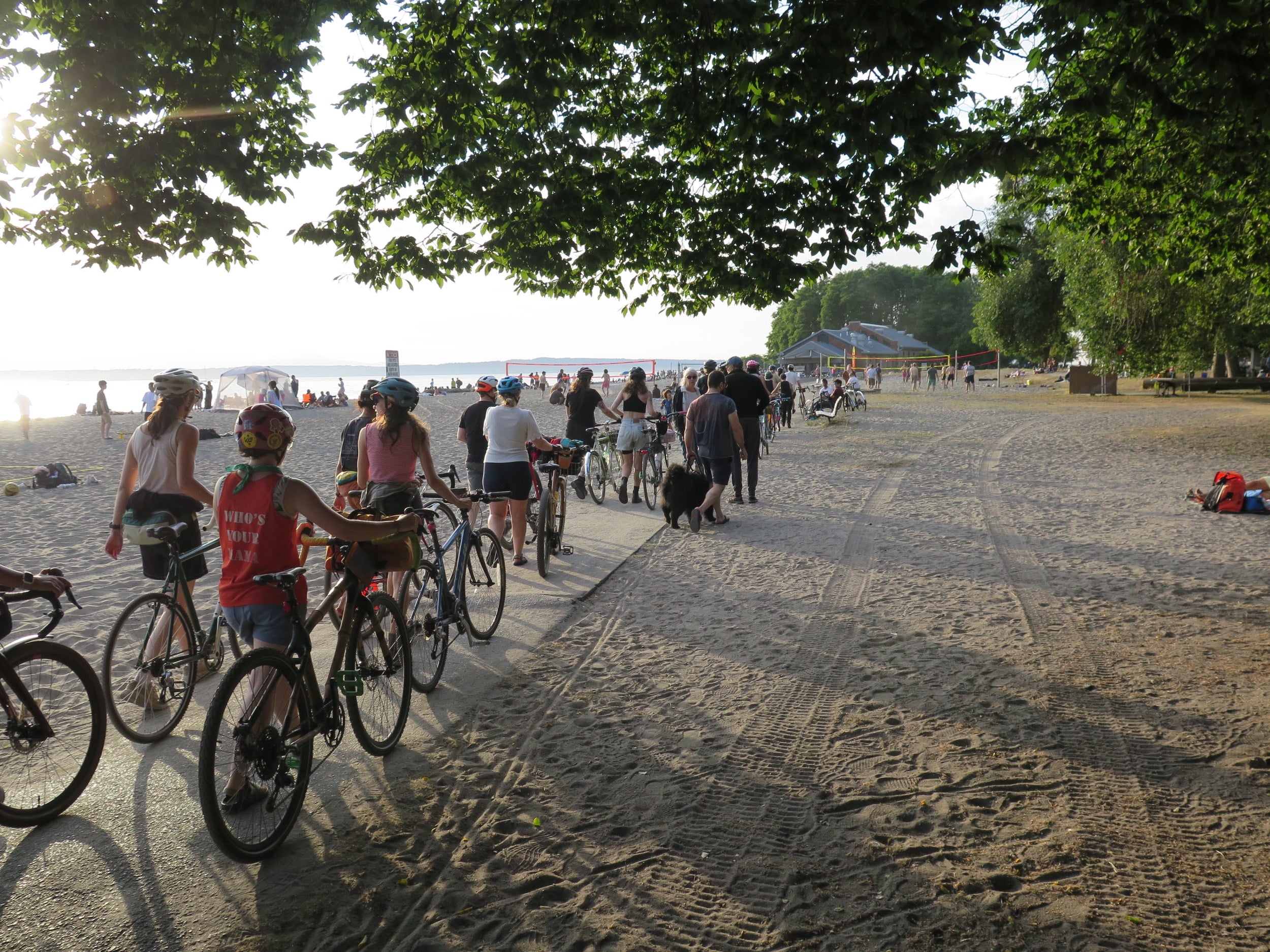 Image of a group ride along the Burke-Gilman Trail in Seattle. The ride is arriving at Golden Gardens Beach.