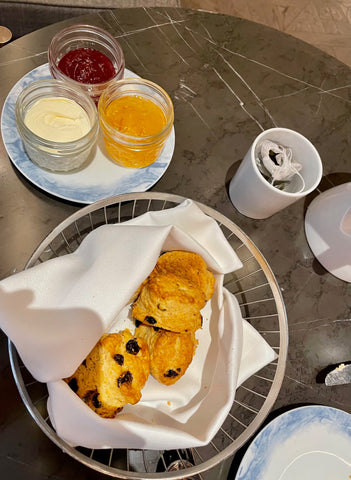 Scones with jam, clotted cream and marmalade.