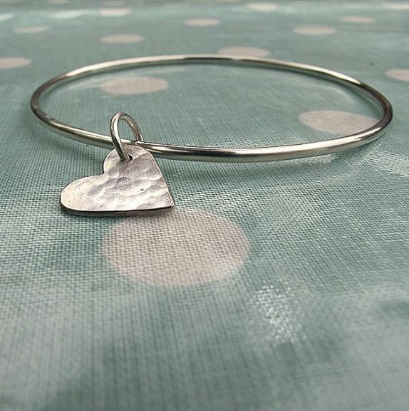 Handmade sterling silver bangle with a hanging hammered heart charm