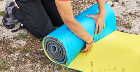 Camping Mat being Rolled Up