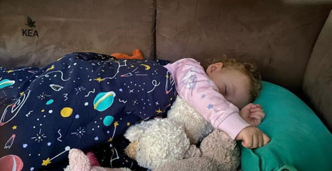 Toddler asleep in New Zealand in a Camper Van