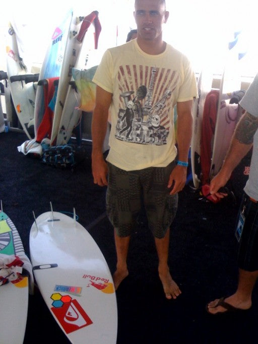 Kelly rode his dual stringer quad 5-10 tangent on his heat to a big win, here he stands next to one of Julian wilsons board