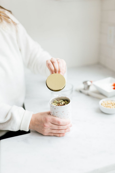 woman opening herbal tea with adaptogens