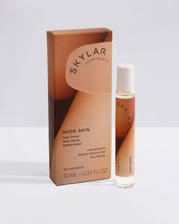 Nude Skin fragrance: Travel-size bottle with an amber scent displayed next to box.