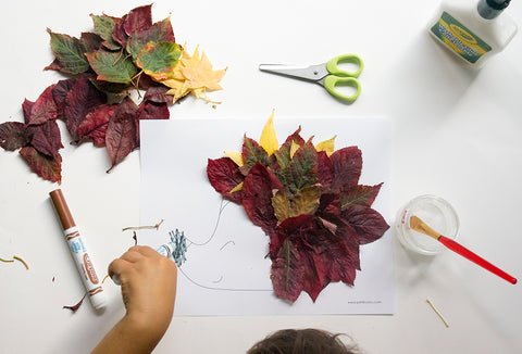 Kid hand coloring our autumn leaves hedgehog nose