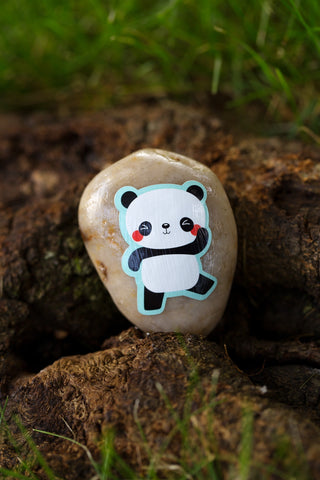 Sticker of a panda glued on a rock