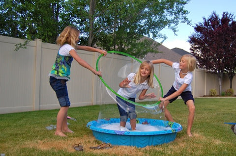 3 kids making giant bubbles