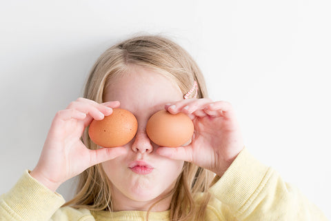Picture of a little girl olding two eggs