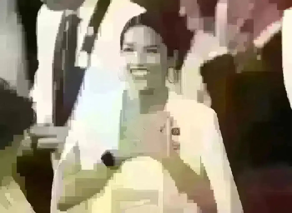 Alexandra Ocasio-Cortez wearing a white outfit with her signature red lip