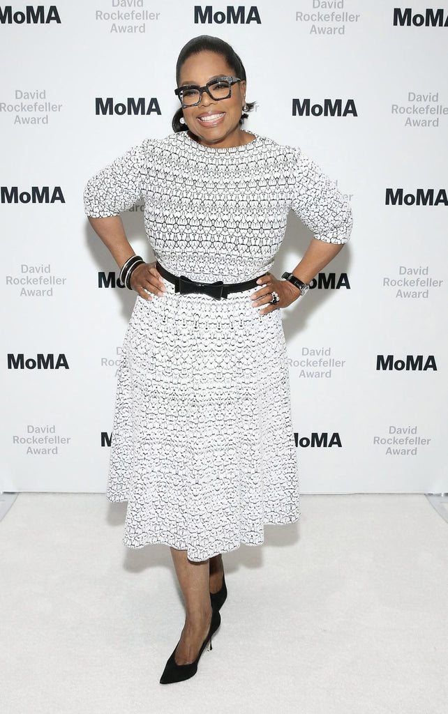 Oprah wearing a white laser-cut dress at MoMa