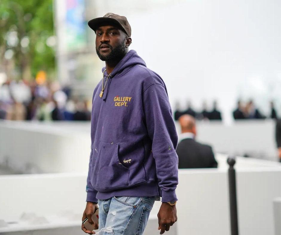 African American fashion designer wearing a purple hoodie and distressed jeans African American fashion icons Black History Month boutiques in Minneapolis