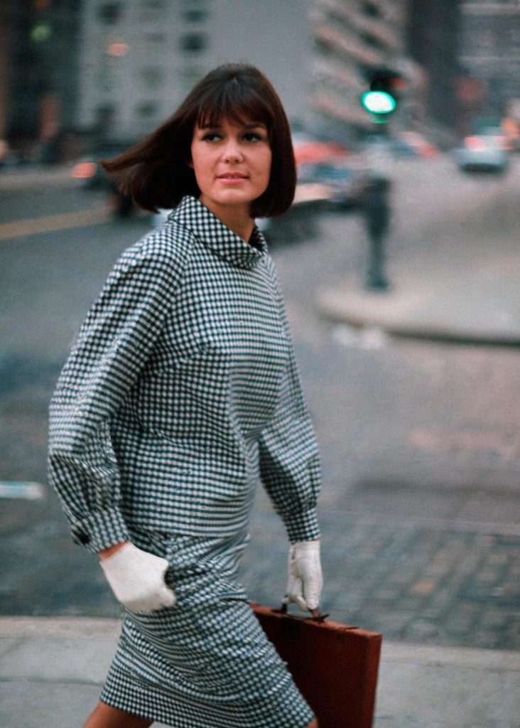 Gloria Steinem wearing a gingham print set with white gloves