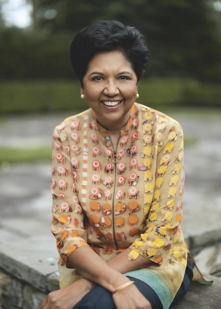 Former CEO of PepsiCo Indra Nooyi wearing a colorful outfit