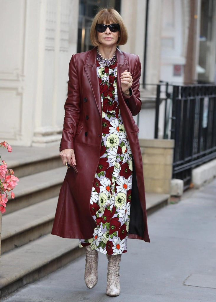 Editor-in-Chief of US Vogue Anna Wintour wearing a long leather trench coat with snakeskin boots