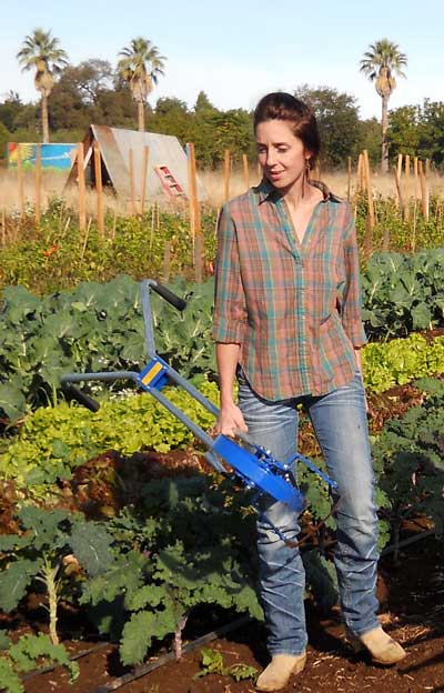 Farmer carrying a Valley Oak Wheel Hoe