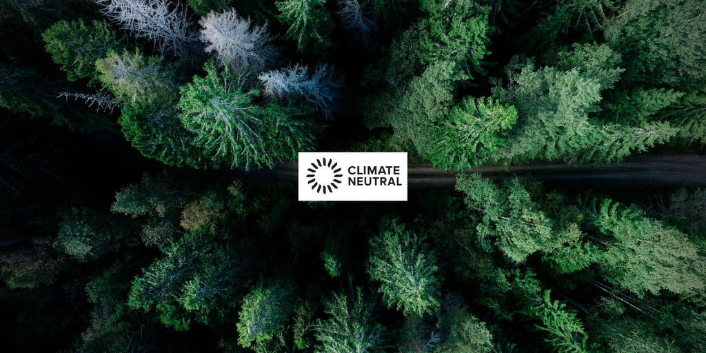 A green forest with the Climate Neutral logo on top.
