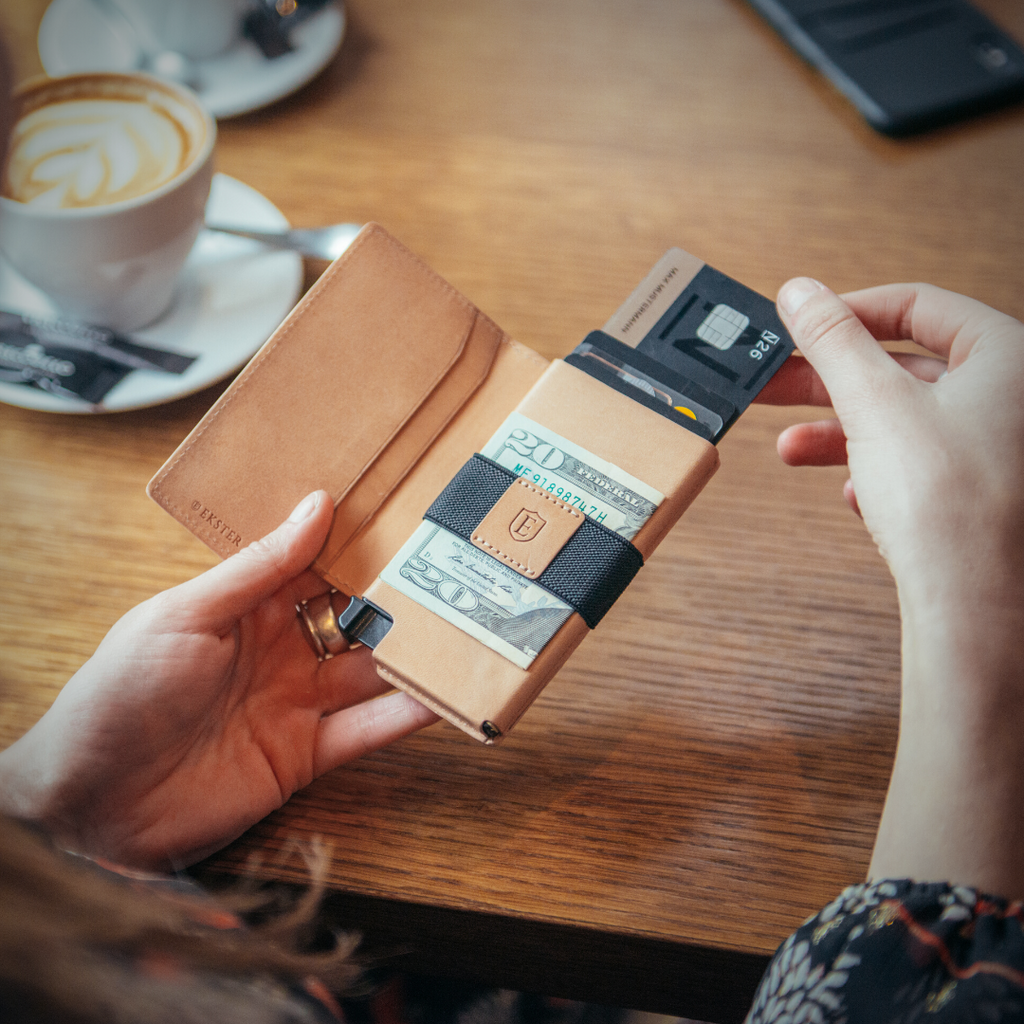 woman removing card from slim RFID wallet