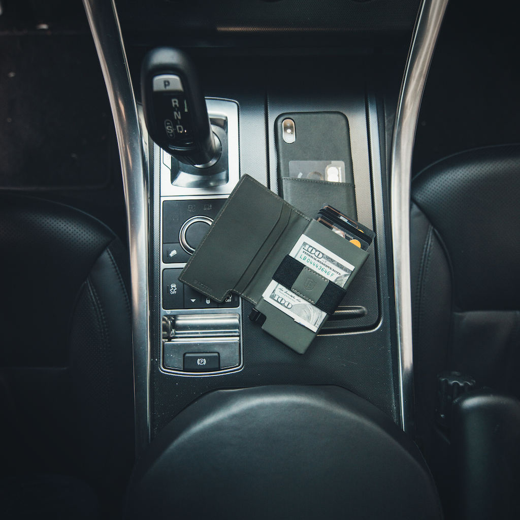 an open Parliament Wallet lying on the center console of a car
